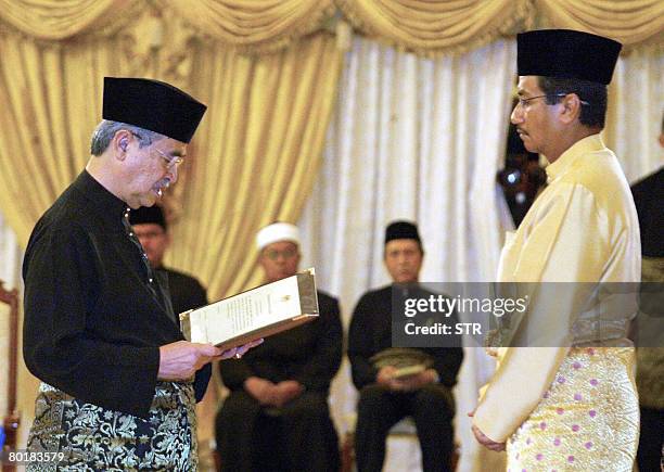 Malaysian Prime Minister Abdullah Ahmad Badawi reads his oath declaration in front of the King of Malaysia, Sultan Mizan Zainal Abidin, as he is...