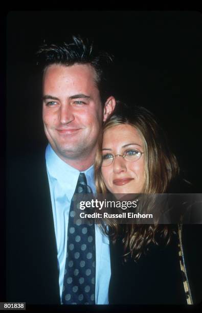 Jennifer Aniston stands with Mathew Perry February 18, 1998 in Los Angeles, CA. They attend the premiere of the film "Kissing A Fool."