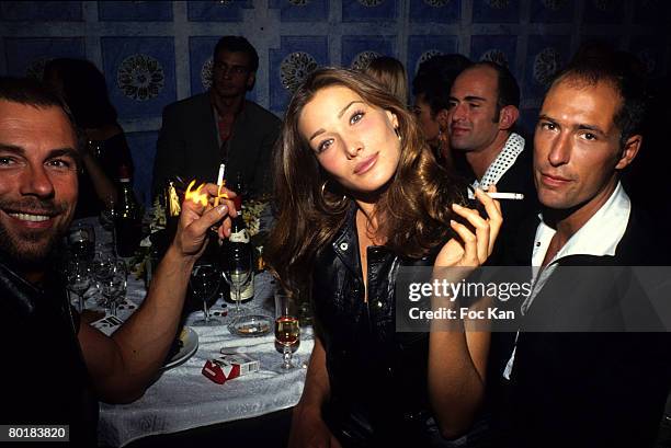 Thierry Mugler, Carla Bruni and Chris Martin attend an After Fashion Show Party at the Bains Club on October 1,1991 in Paris, France.