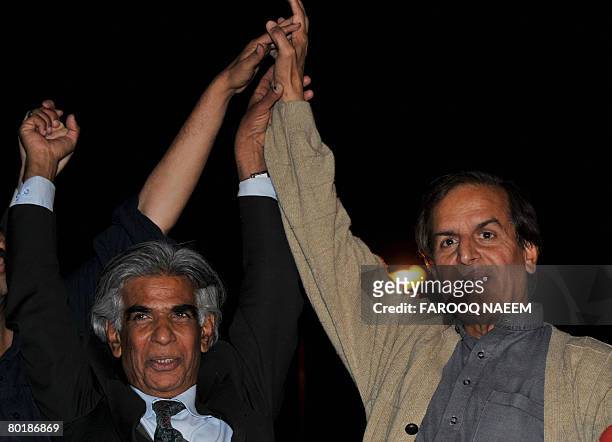 Senior leader Pakistan Muslim League Nawaz Javed Hashmi holds hand of anti-government lawyer Ali Ahmed Kurd during a protest rally outside the...