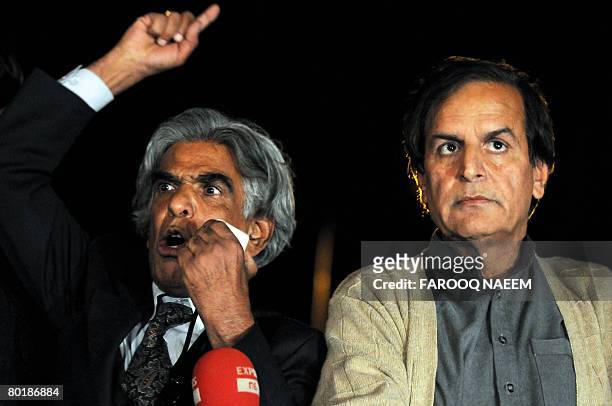Senior leader Pakistan Muslim League Nawaz Javed Hashmi listens to anti-government lawyer Ali Ahmed Kurd addresses to the protesters outside the...