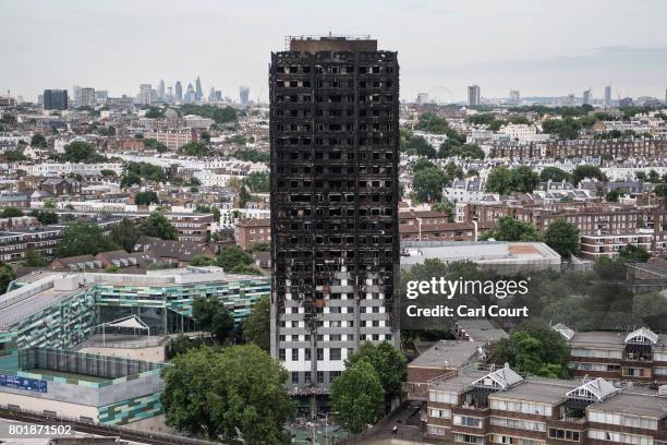 The remains of Grenfell Tower are seen from a neighbouring tower block on June 26, 2017 in London, England. 79 people have been confirmed dead and...