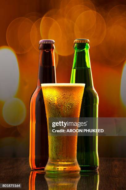 cold craft beer of two bottles and a glass - bottles glass top stockfoto's en -beelden