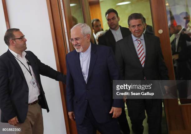 Iranian Minister of Foreign Affairs Mohammad Javad Zarif and German Foreign Minister Sigmar Gabriel arrive to speak to the media following talks on...