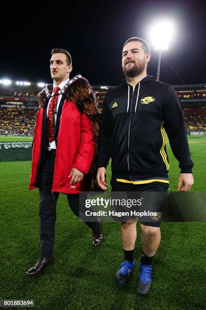 Dane Coles of the Hurricanes talks to Sam Warburton of the Lions after presenting him with at feathered Maori cloak, or Korowai, during the match...