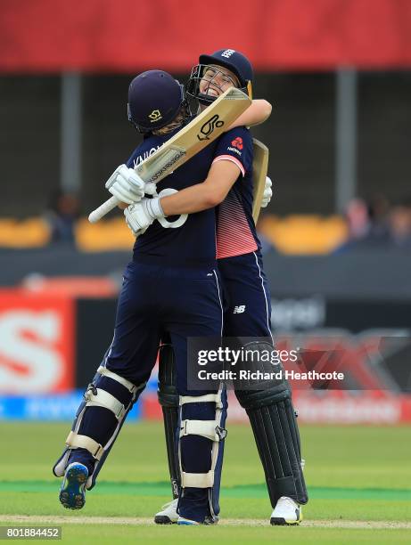 Heather Knight and Natalie Sciver of England celebrate both of them reaching their centuries during the Women's ICC World Cup group match between...