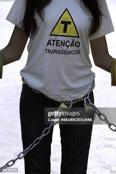 An activists of environmentalist group Greenpeace chains herself to block the factory's entrance of Brazilian dairy company 'Vigor', during a...