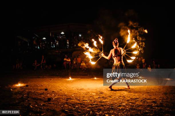 amazing fire show at night on the beach. - juggling act stock pictures, royalty-free photos & images