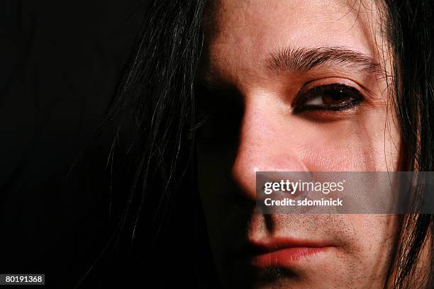 a close up on a male face. - emo guy stock pictures, royalty-free photos & images