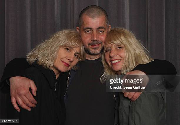 Twins Gisela Getty and Jutta Winkelmann pose for a photograph with Jamal Tuschick before a reading from their new book "Twins" at the Babylon movie...