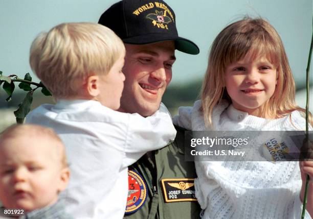 Navy spy plane crewmember Josef Edmonds from Davis, CA greets his children April 14, 2001 upon arrival in Whidbey Island, Washington. Crewmembers...