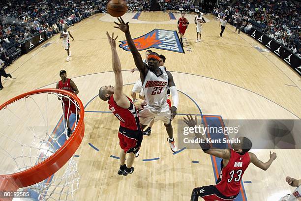 Jason Richardson of the Charlotte Bobcats shoots a layup over Anthony Parker of the Toronto Raptors during the game at the Charlotte Bobcats Arena on...