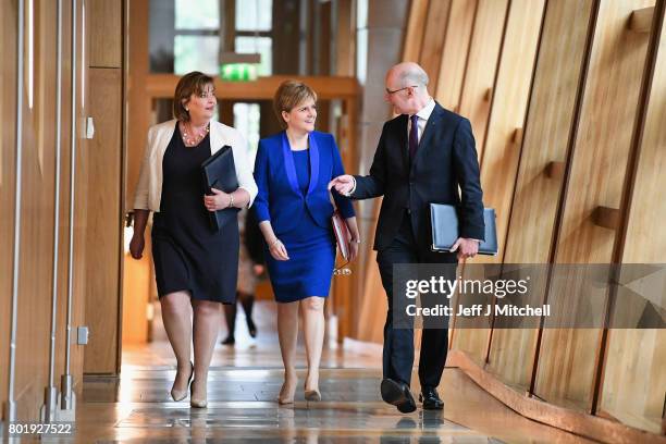 Scotland's First Minister Nicola Sturgeon arrives with John Swinney and Fiona Hyslop before making an announcement to parliament regarding a second...