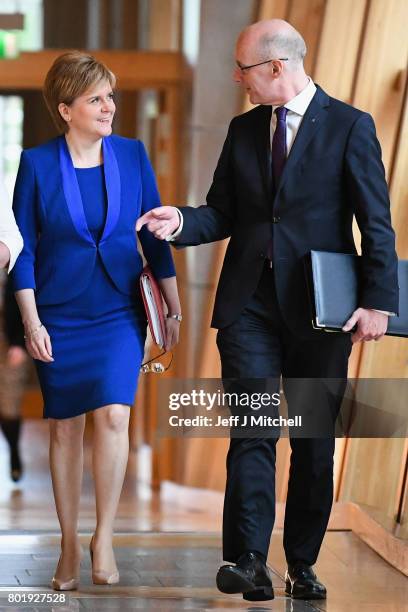 Scotland's First Minister Nicola Sturgeon arrives with John Swinney before making an announcement to parliament regarding a second Scottish...