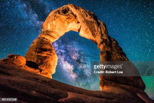 a portal to the milky way at delicate arch - utah arch stock pictures, royalty-free photos & images