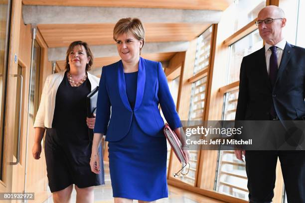 Scotland's First Minister Nicola Sturgeon, arrive with John Swinney and Fiona Hyslop before making an announcement to parliament regarding a second...