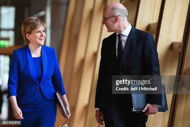 Scotland's First Minister Nicola Sturgeon arrives with John Swinney before making an announcement to parliament regarding a second Scottish...