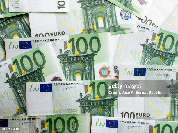 background shot of various paper currencies from 100 euros - euro scheine stock-fotos und bilder