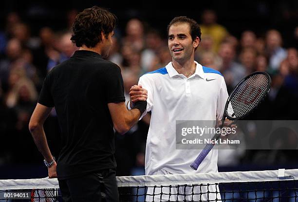 Pete Sampras shakes hands with Roger Federer of Switzerland after Federer won in a third set tie break during their exhibition match on March 10,...