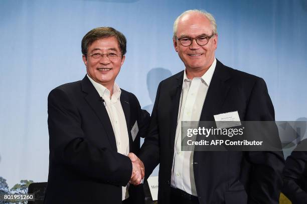 Ren Jianxin , Chairman of China National Chemical Corporation and newly elected chairman of the Board of Directors of Syngenta AG shakes hands with...
