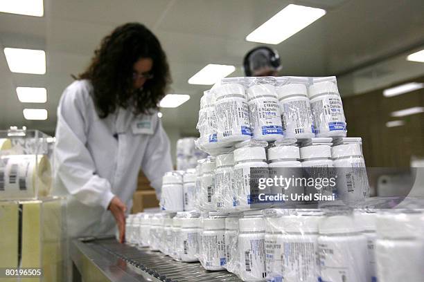 Teva Pharmaceuticals workers pack drugs in a clean room at the company's manufacturing plant March 10, 2008 in Jerusalem. Teva is regarded as the...