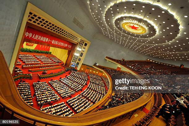 Chinese Communist Party members and delegates attending a plenary session of the National People's Congress at the Great Hall of the People in...