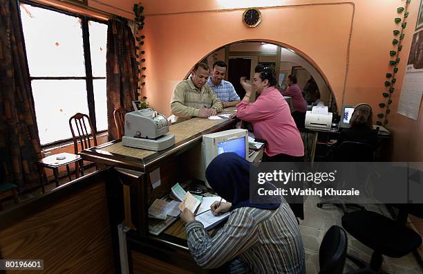 Customers and employees of Warka Bank for Investment and Finance are seen at the bank on March 11, 2008 in Baghdad, Iraq. Warka Bank for Investment...