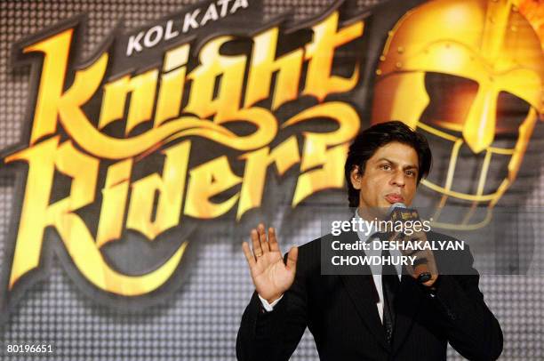 Indian actor and co-owner of the 'Kolkata' cricket team, Shahrukh Khan gestures as he stands beside the logo of the team 'Kolkata Knight Riders'...