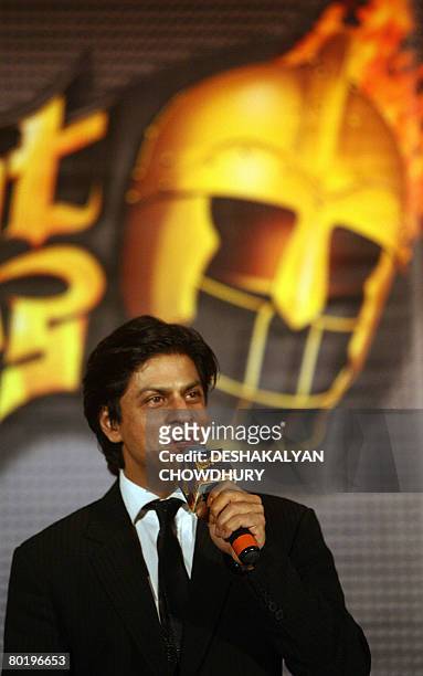 Indian actor and owner of the 'Kolkata' cricket team, Shahrukh Khan gestures standing besdie the logo of the team namely 'Kolkata Knight Riders'...