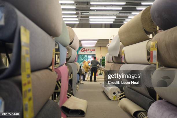 Customers are served in a branch of the Carpet Right store on June 27, 2017 in south London, England. The national carpeting chain has announced that...