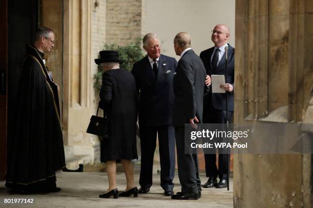 Queen Elizabeth II and Prince Philip, Duke of Edinburgh are greeted by their son Prince Charles, Prince of Wales as they arrive at the funeral...