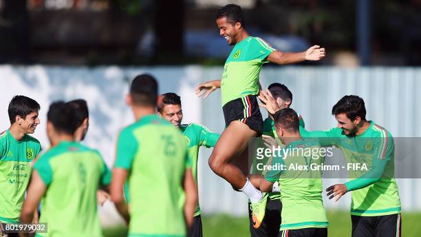 Giovani dos Santos is lifted in the air by his team mates during a Mexico training session at Adler training ground ahead of their FIFA...