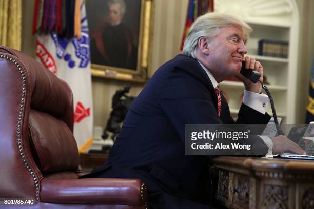 President Donald Trump speaks on the phone with Irish Prime Minister Leo Varadkar on the phone in the Oval Office of the White House June 27, 2017 in...