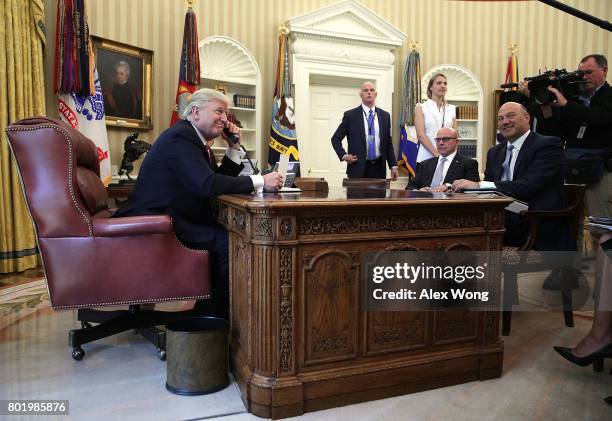 President Donald Trump speaks on the phone with Irish Prime Minister Leo Varadkar on the phone as National Economic Council Director Gary Cohn and...