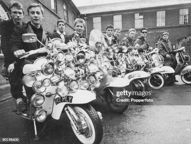 Group of mods with their decorated scooters outside the Labour Exchange in Peckham, south London, 8th May 1964.
