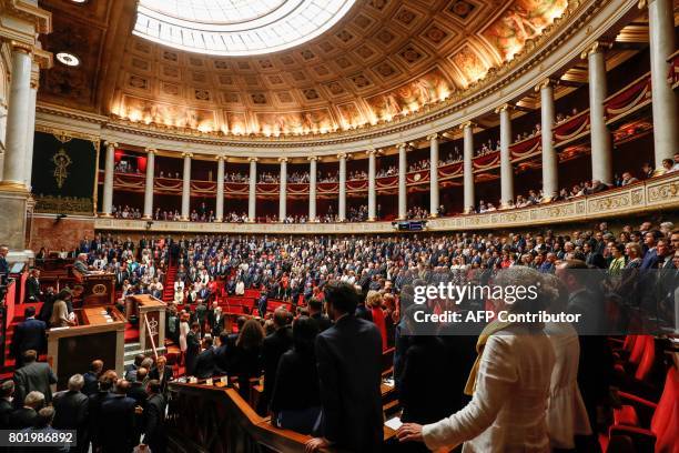 Lawmakers stand up at the start of the speech by French Les Republicains party lawmaker Bernard Brochand the most senior member of the French...