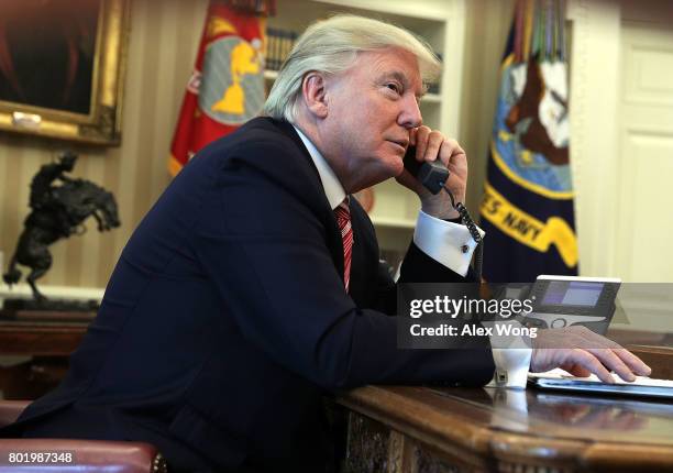 President Donald Trump speaks on the phone with Irish Prime Minister Leo Varadkar on the phone in the Oval Office of the White House June 27, 2017 in...