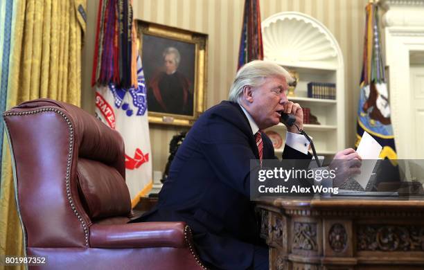 President Donald Trump speaks on the phone with Irish Prime Minister Leo Varadkar on the phone in the Oval Office of the White House June 27, 2017 in...