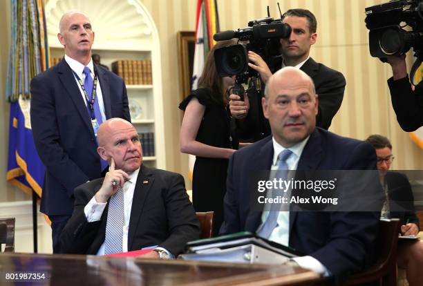 National Economic Council Director Gary Cohn and National Security Adviser H. R. McMaster sit in during a phone call between U.S. President Donald...