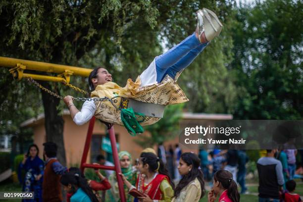 Kashmiri children enjoy the amusement rides on the second day of the Eid-Al-Fitr, a Muslim festival, on June 27, 2017 in Srinagar, the summer capital...