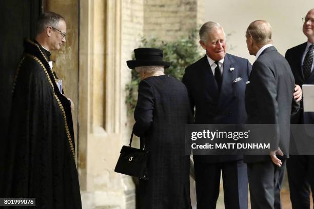 Britain's Queen Elizabeth II and Britain's Prince Philip, Duke of Edinburgh are greeted by Britain's Prince Charles, Prince of Wales as they arrive...