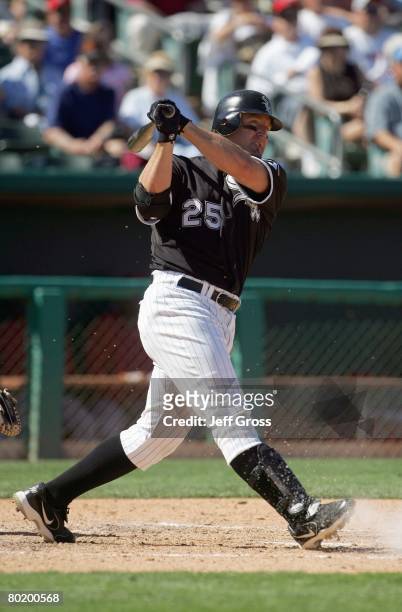 Jim Thome of the Chicago White Sox swings at the pitch during a spring training game against the Los Angeles Angels of Anaheim at Tucson Electric...