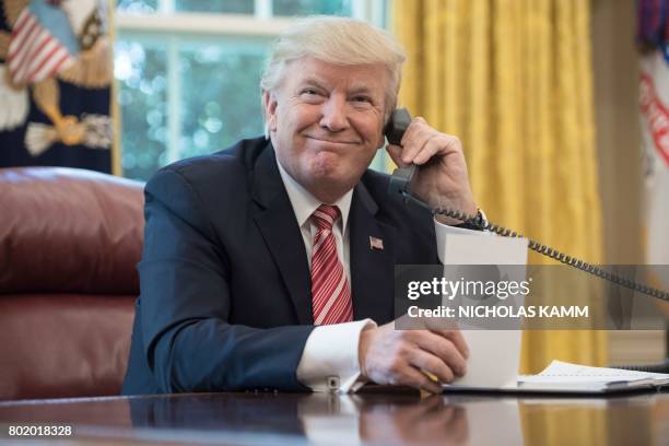 President Donald Trump waits to speak on the phone with Irish Prime Minister Leo Varadkar to congratulate him on his recent election victory in the...