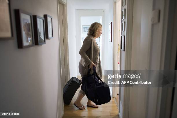 Sixteen-year resident Fatmire Kurtani packs belongings as she prepares to evacuate from her 16th floor flat in the Taplow Tower residential block on...