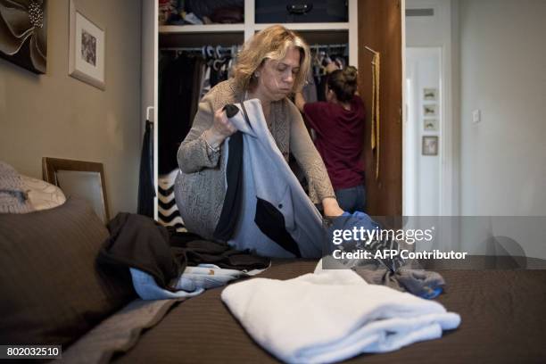 Sixteen-year residents Fatmire Kurtani and daughter Diona pack their belongings as they prepare to evacuate from their 16th floor flat in the Taplow...