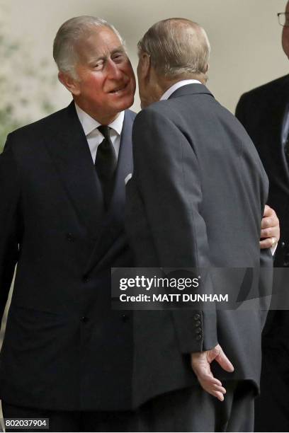 Britain's Prince Philip, Duke of Edinburgh is greeted by Britain's Prince Charles, Prince of Wales at the funeral service of the 2nd Countess...