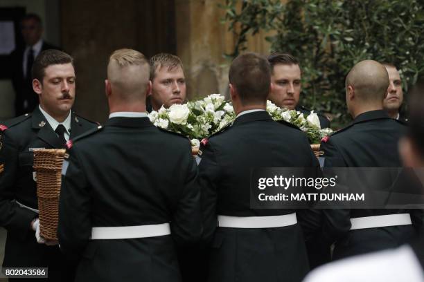 Members of the Second Battalion, Princess Patricia's Canadian Light Infantry , known as "The Patricia's", carry the wicker casket, decorated with...