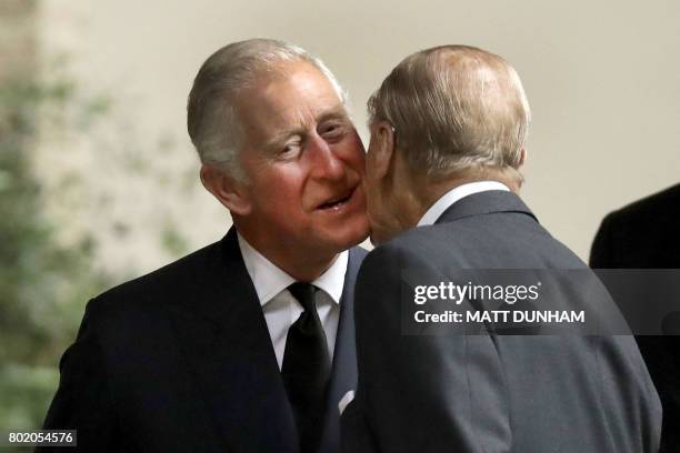 Britain's Prince Philip, Duke of Edinburgh is greeted by Britain's Prince Charles, Prince of Wales at the funeral service of the 2nd Countess...