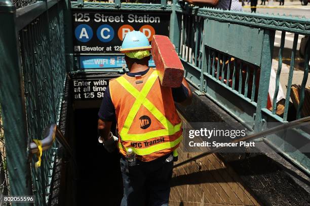 Metropolitan Transportation Authority worker enters a Harlem subway station where a morning train derailment occurred on June 27, 2017 in New York...