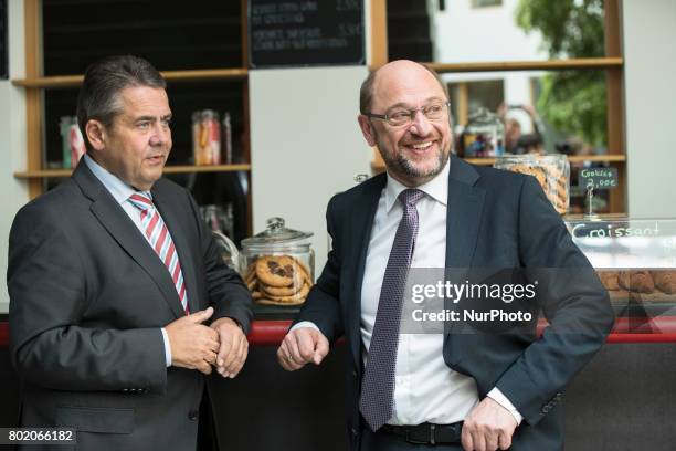 Chancellor Candidate and chairman of the Social Democratic Party Martin Schulz chats with foreign minister Sigmar Gabriel after a news conference to...